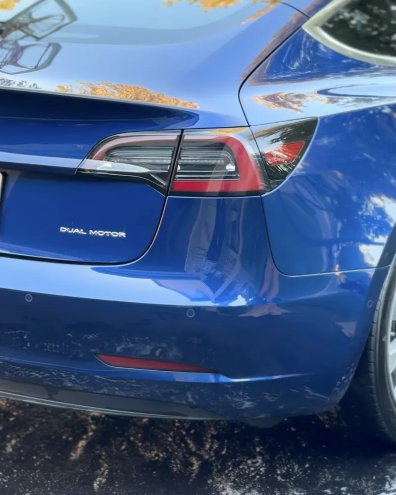 Blue Tesla Model 3 with a freshly washed, glossy finish